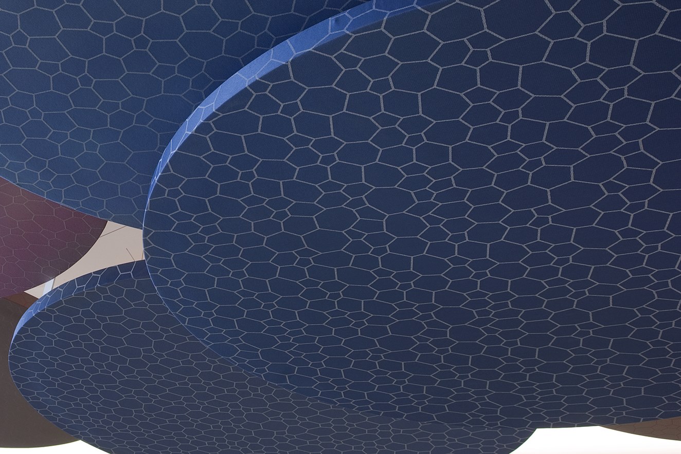 close-up of suspended fabric covered circular cloud panels